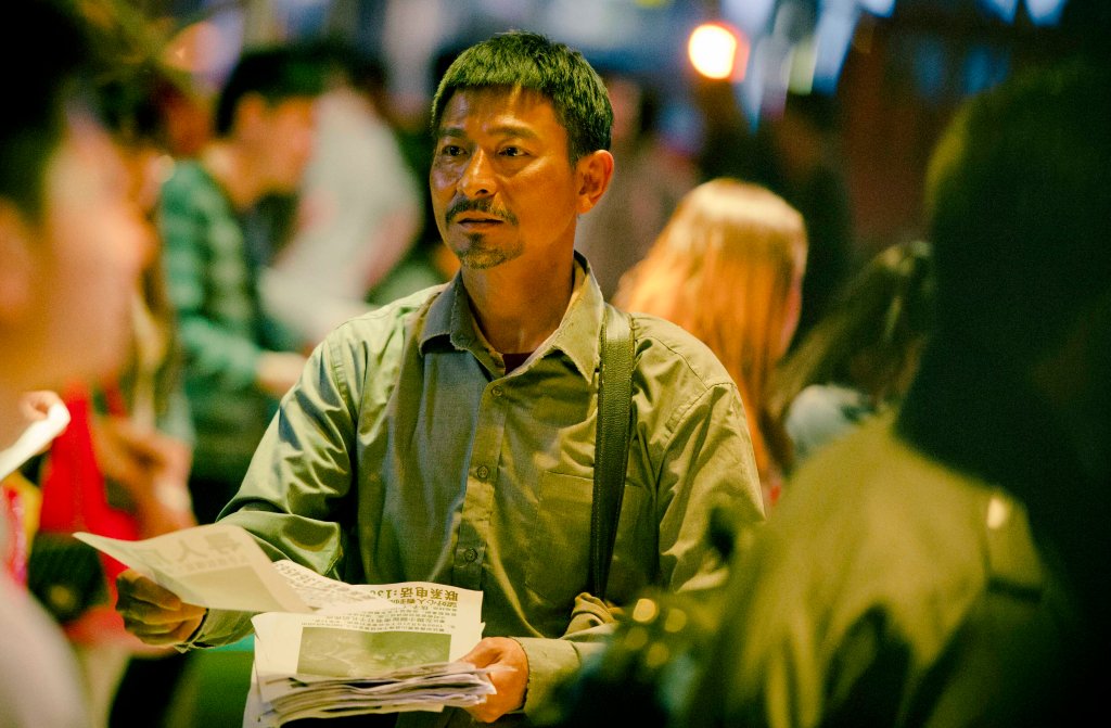 Lei Zekuan (Andy Lau) passes out fliers with photos of his missing son in a scene from the Chinese film Lost and Love. (China Lion Film Distribution)