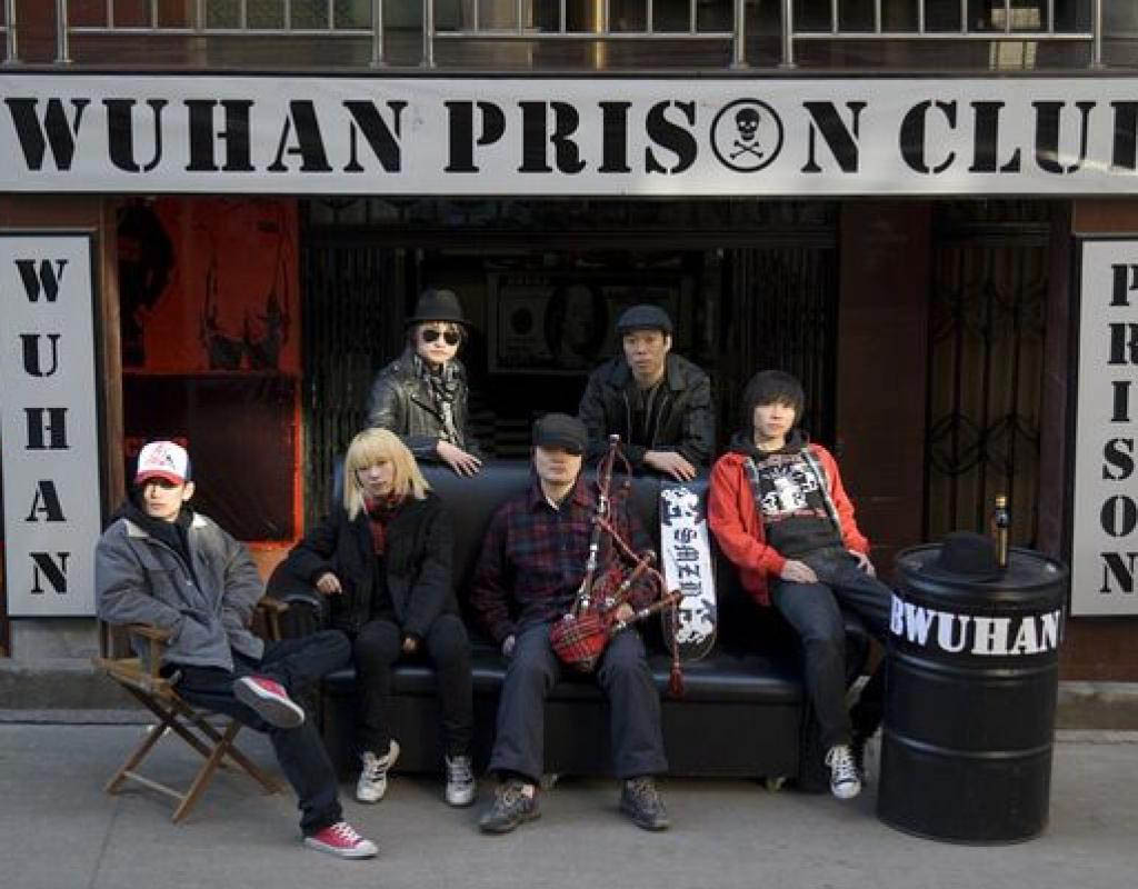 Wu Wei, standing, centre rear, with his fellow punk musicians outside his bar in Wuhan, China. Note the bagpipes! The history of Chinese punk music is explored in the documentary Never Release My Fist, by Shuibo Wang.