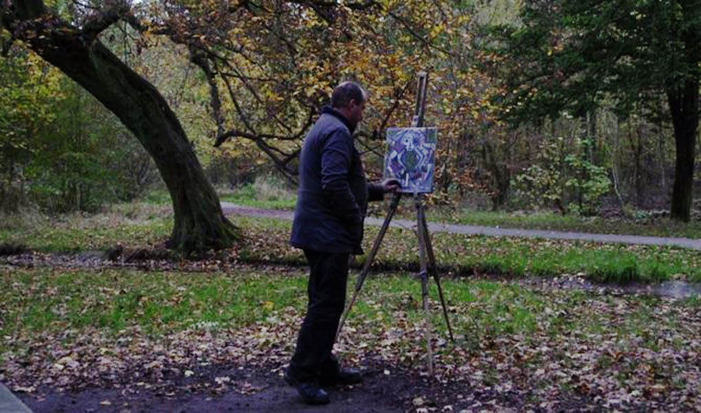 A man paints in nature, though not from nature, in a scene from the French documentary film The Woods Dreams Are Made Of (Le Bois Dont Les Rves Sont Faits).