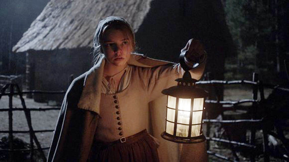 In this scene from the horror film The Witch, Thomasin (Anya Taylor-Joy) has heard disturbing sounds in the night. (Remstar Pictures)