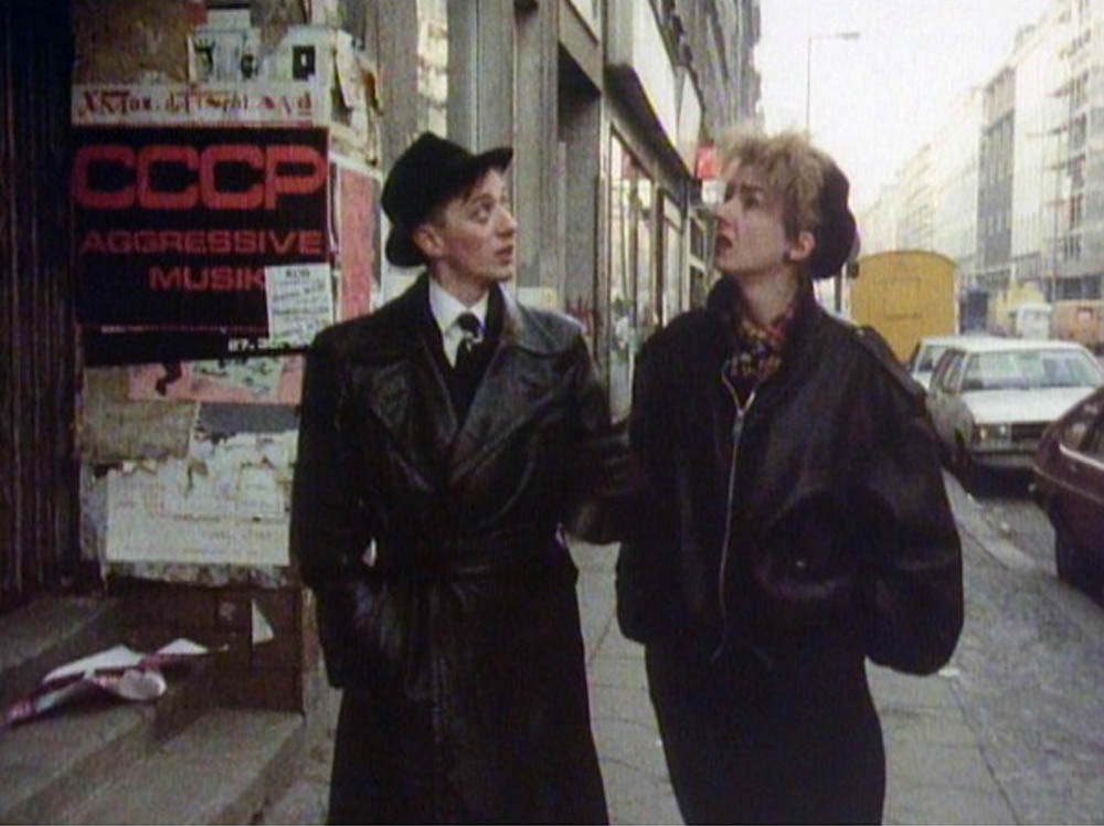 In a scene from the documentary film B-Movie Lust & Sound in West-Berlin 1979-1989, Mark Reeder gives TV presenter Muriel Gray a tour of West Berlin in 1983.