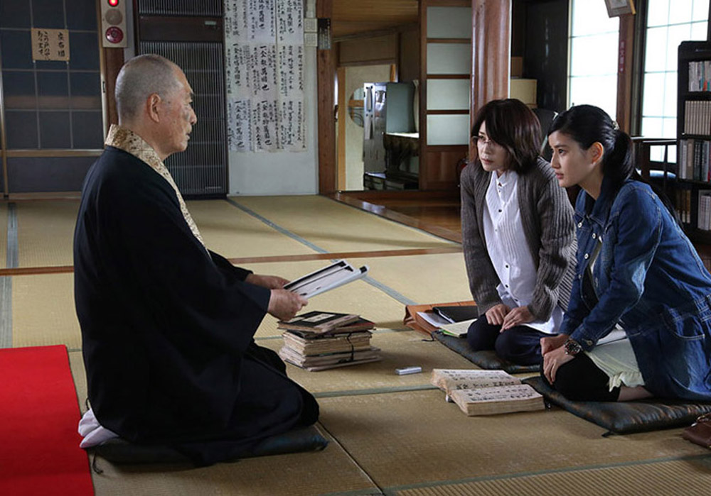 A writer (Yuko Takeuchi) and a student (Ai Hashimoto) seek information from a Buddhist priest in the Japanese film Inerasable, directed by Yoshihiro Nakamura. Inerasable is being shown at the Fantasia International Film Festival in Montreal.