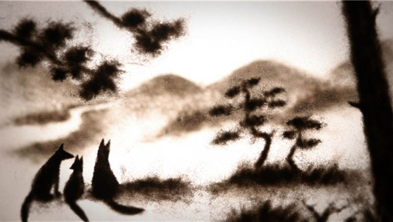A fox family in sihouette in the animated film Japanese Fox Fears. Director Miya Sato created the images using sand and paint on glass.